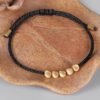 Pulsera Tibetana Negra Trenzada a Mano con Bolas de Cobre-1